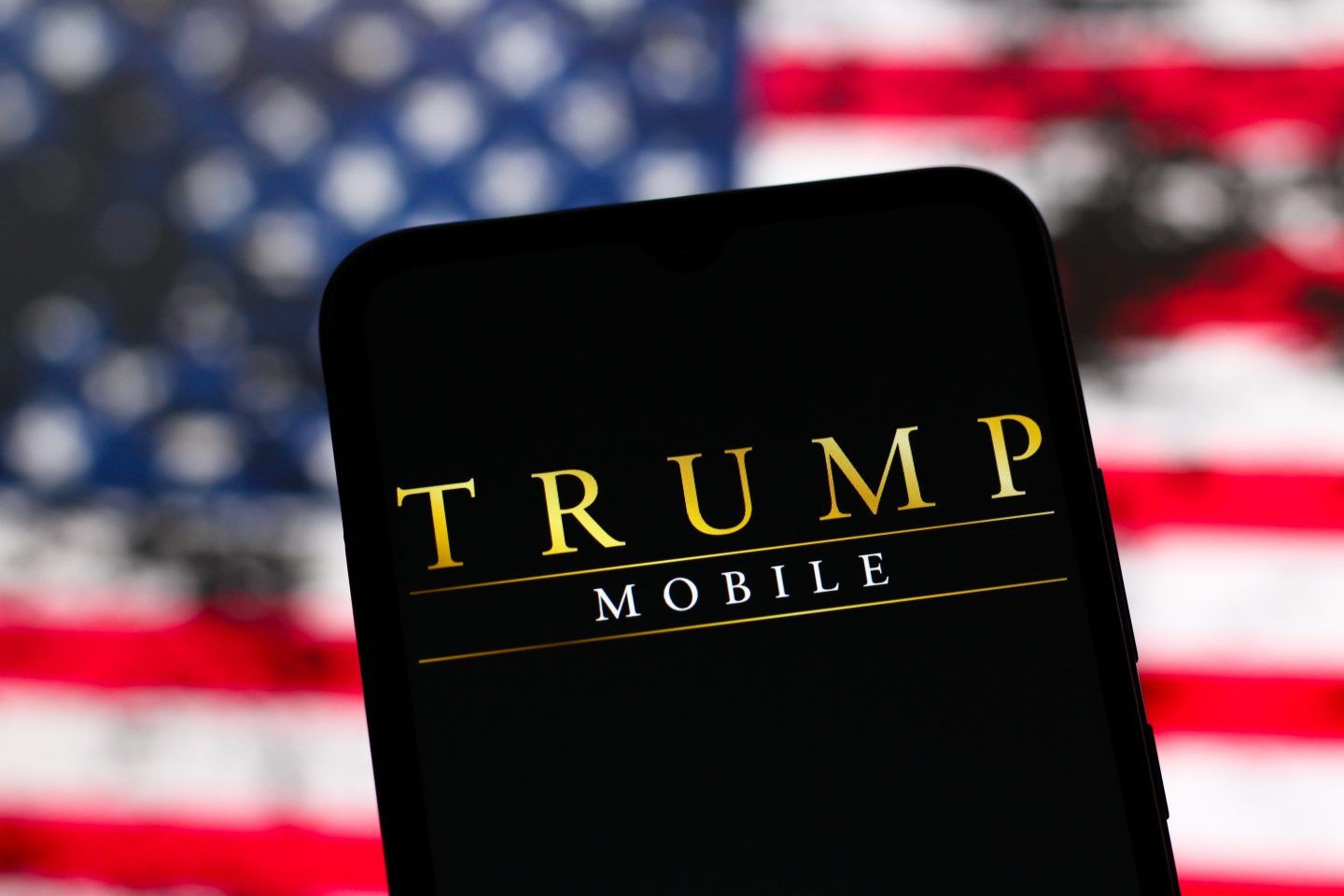 A black phone with the words "Trump Mobile" in front of an American flag