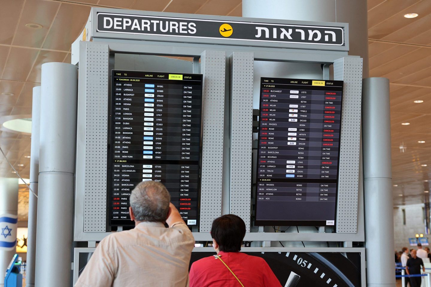passengers look at the departures board at Israel's main airport
