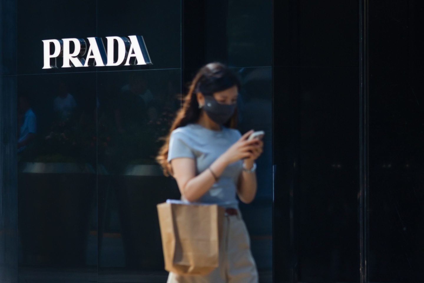 A shopper walks past a Prada store