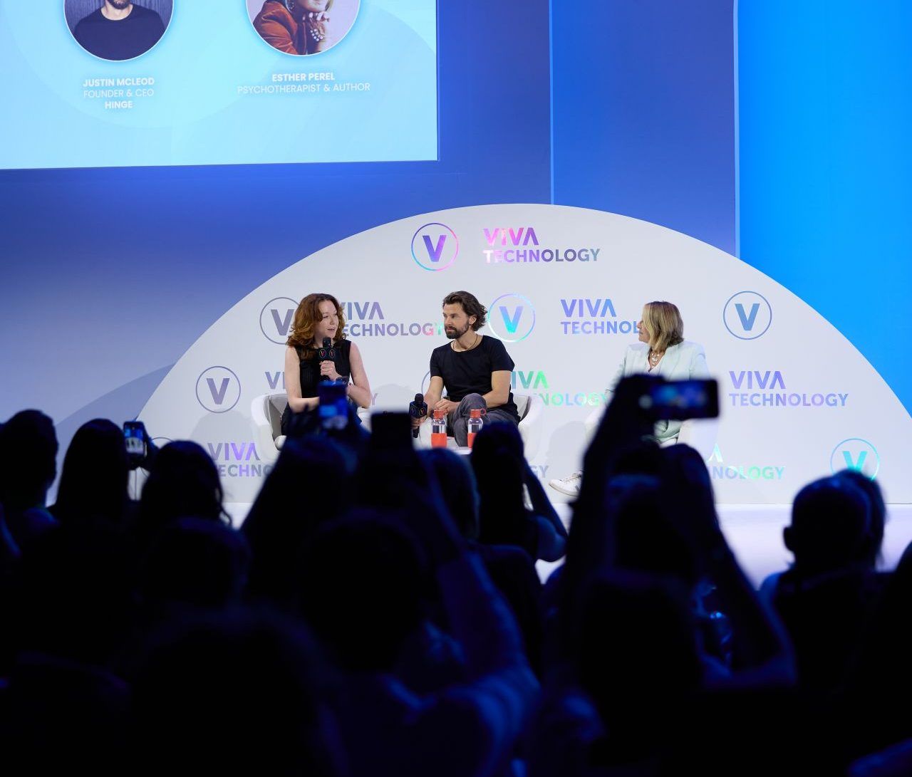 Coins2Day's Beatrice Nolan and Hinge's McLeod sitting and talking on a blue stage at Vivatech.