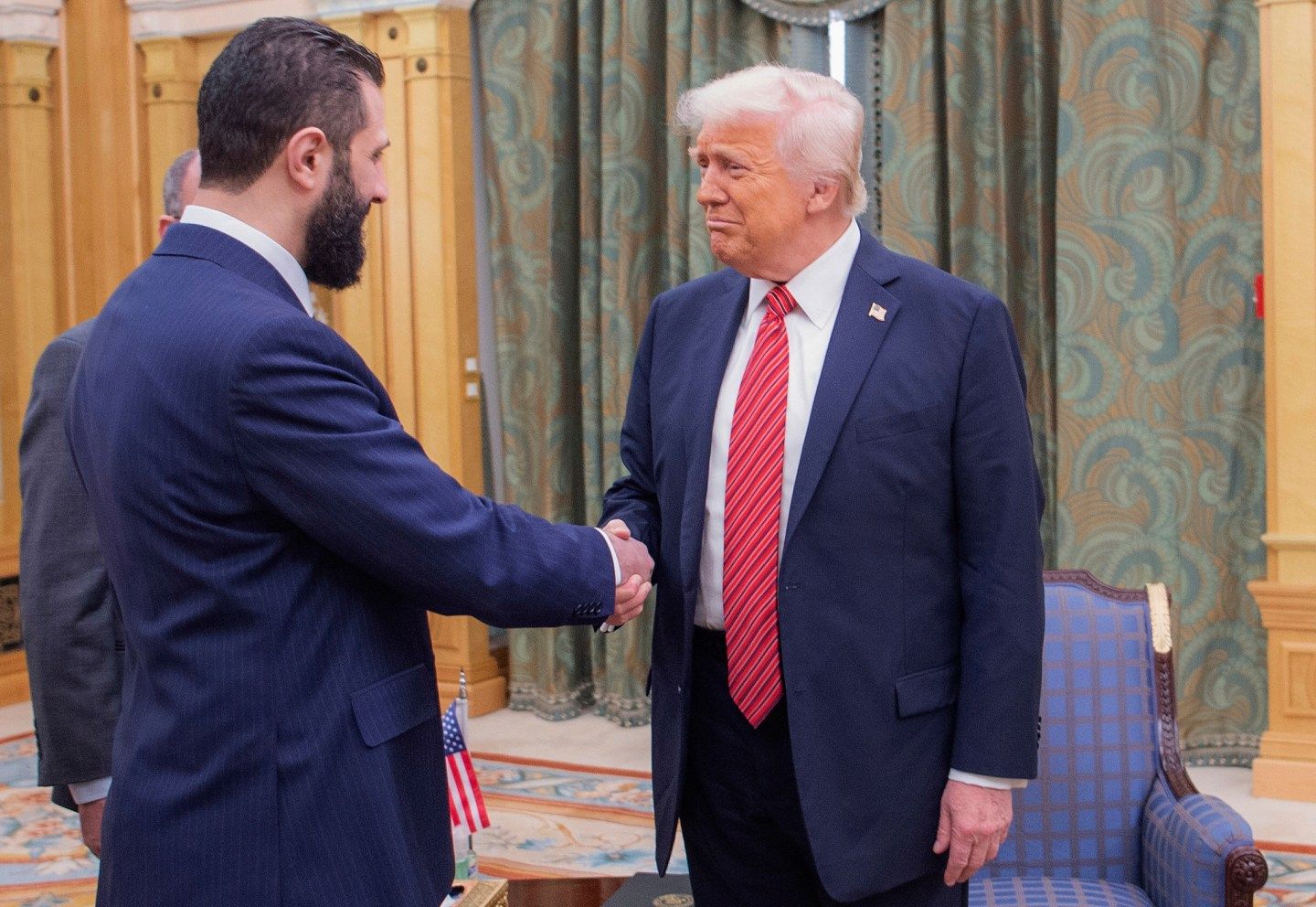 President Donald Trump, right, shakes hands with Syria's interim President Ahmad al-Sharaa, in Riyadh, Saudi Arabia, May 14, 2025. 