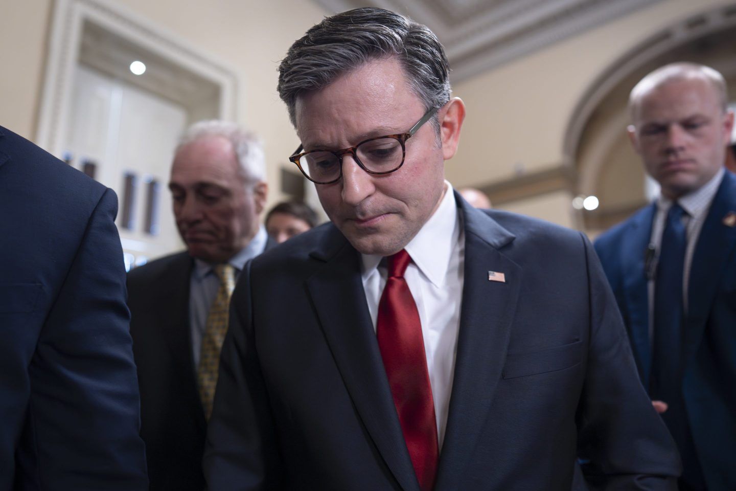 Speaker of the House Mike Johnson, R-La., walks through a crowd of reporters as he tries to push President Donald Trump's tax and spending bill across the finish line as conservative and moderate GOP holdouts slow that effort, at the Capitol in Washington, on July 2, 2025. 
