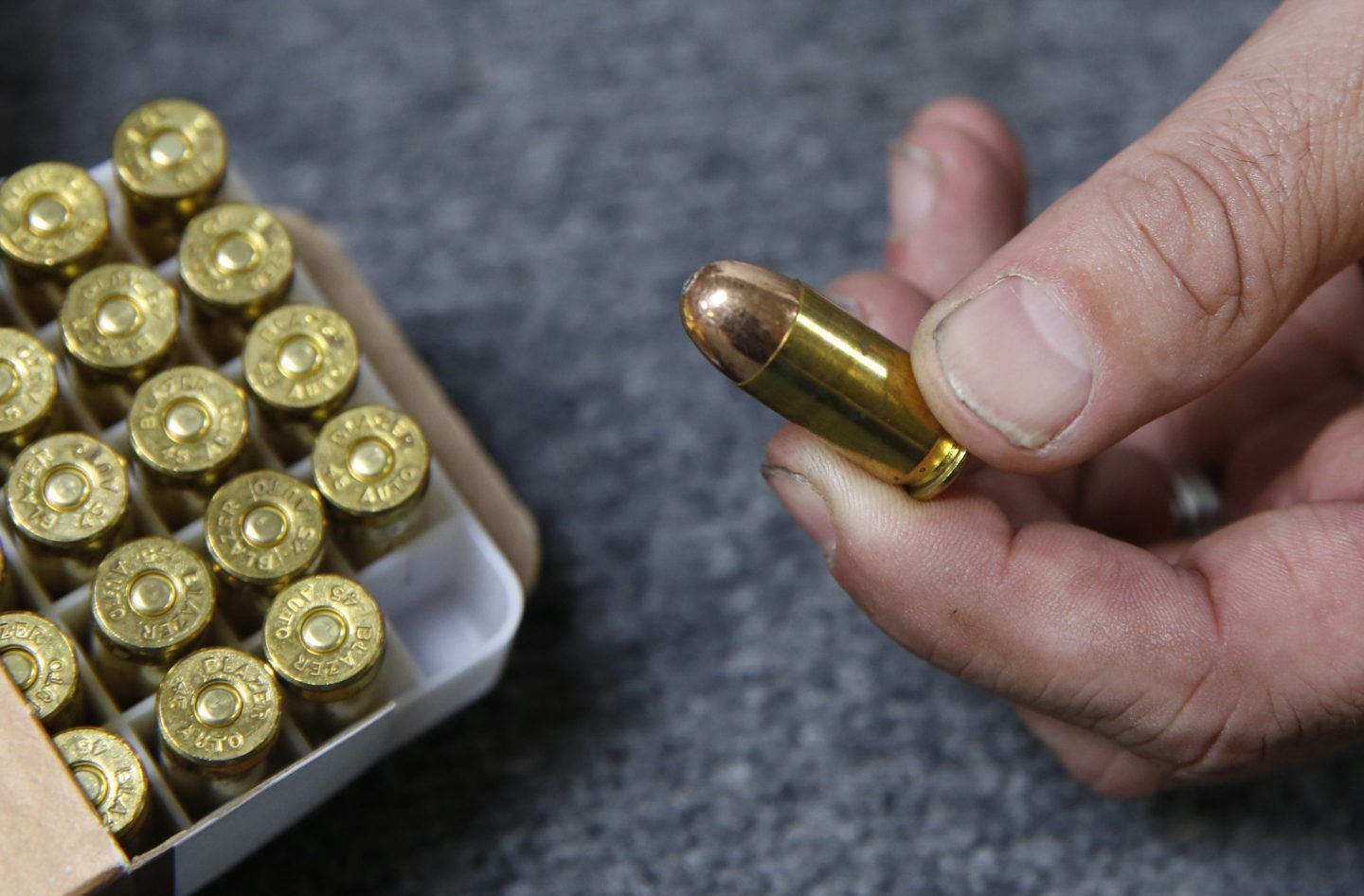 Chris Puehse, owner of Foothill Ammo, displays .45-caliber ammunition for sale at his store in Shingle Springs, Calif., June 11, 2019. 