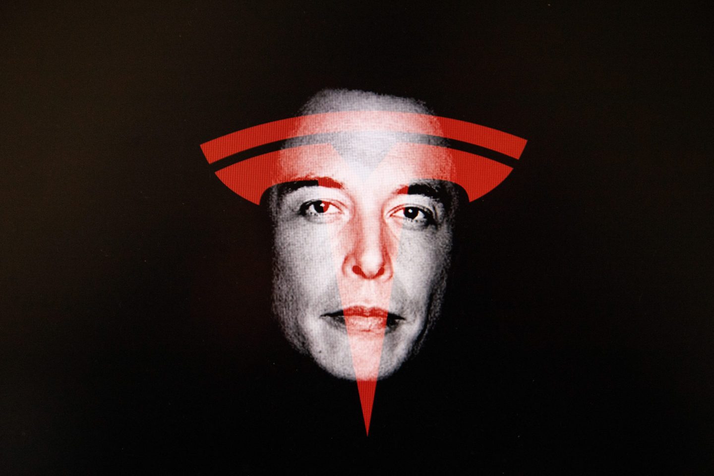 The Tesla logo in red superimposed on Elon Musk's face