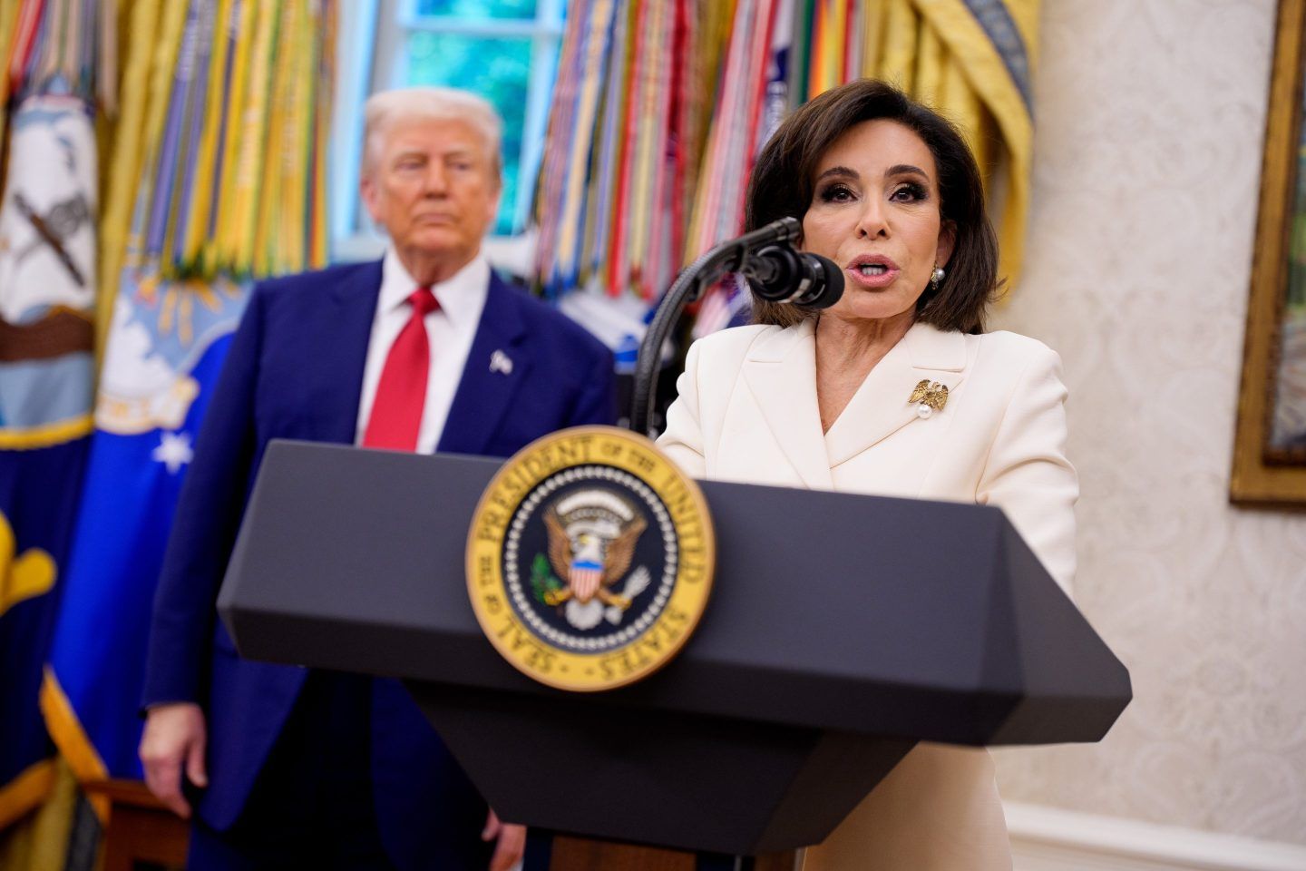 U.S. Attorney for Washington, D.C. Jeanine Pirro at a podium with President Donald Trump