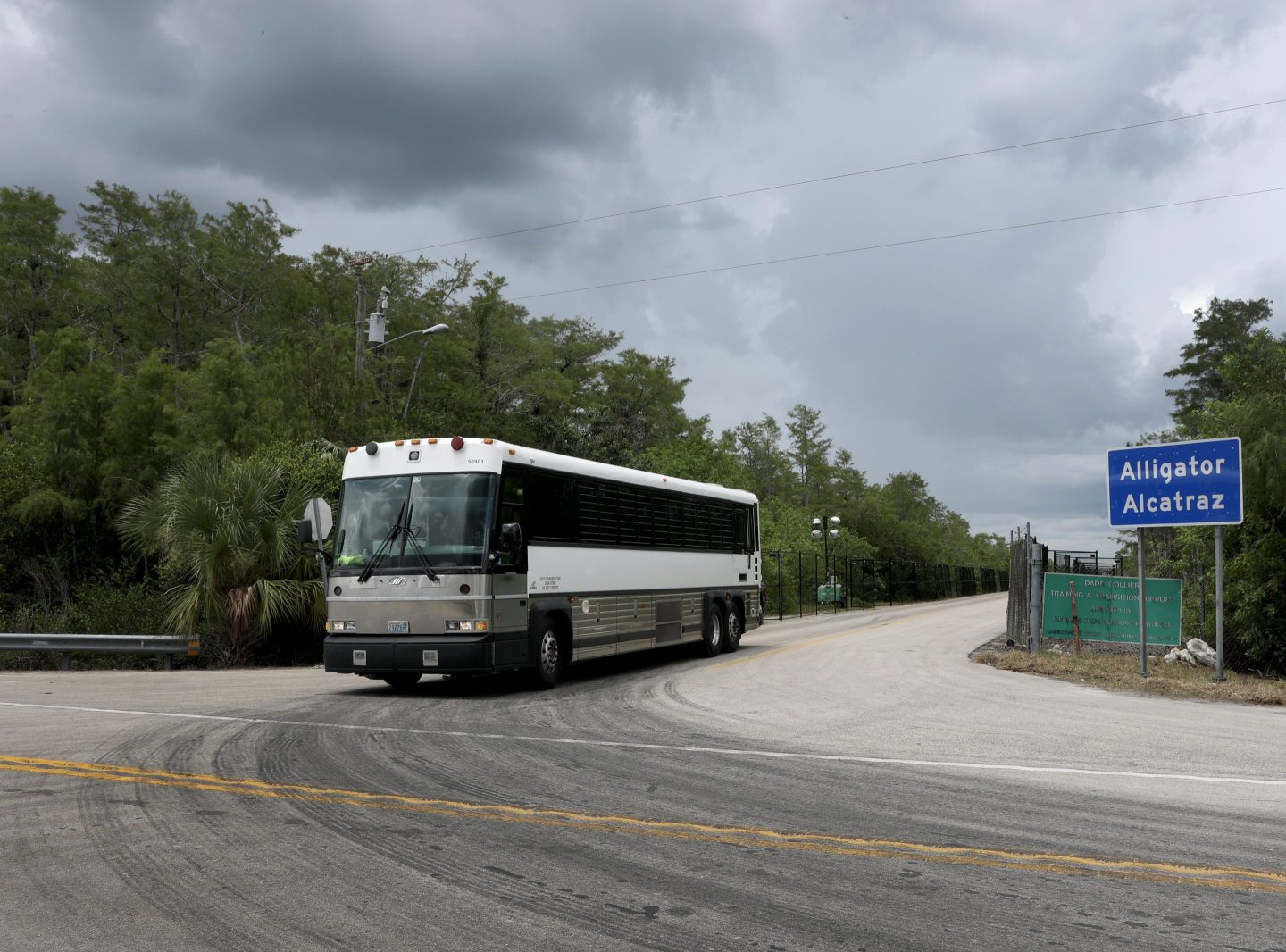 A bus leaving "Alligator Alcatraz"