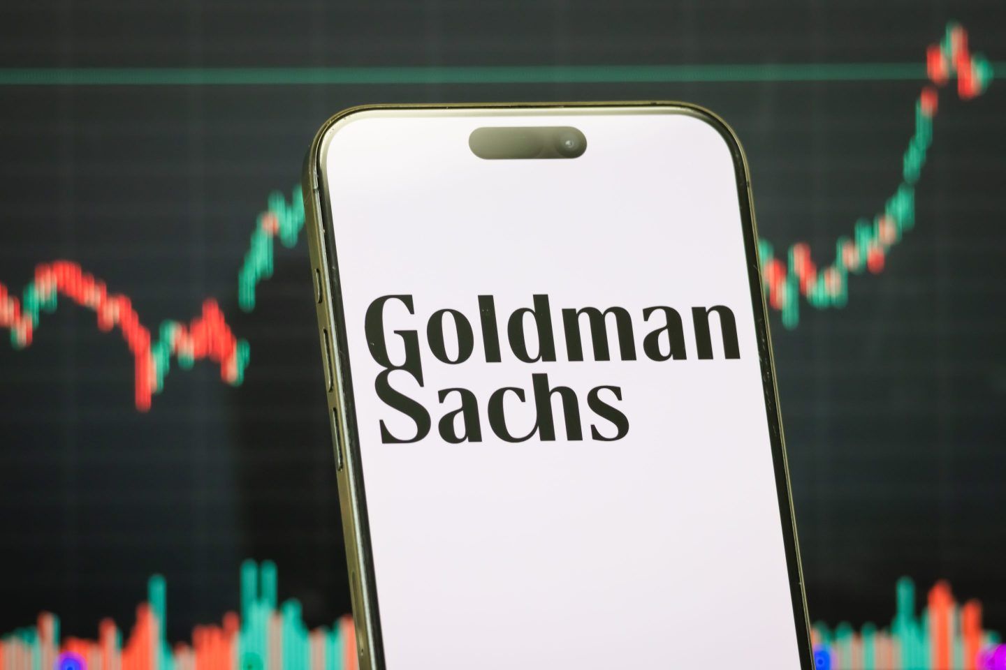 This photo illustration shows a smartphone displaying the logo of The Goldman Sachs Group.