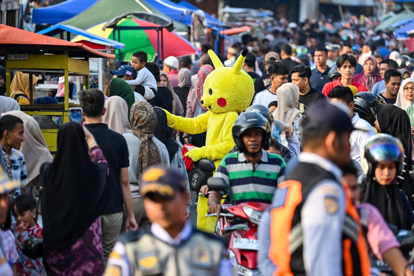 Muslims purchase food and drinks for the Iftar meal after breaking their fast during the month of Ramadan in Banda Aceh on March 13, 2024. 