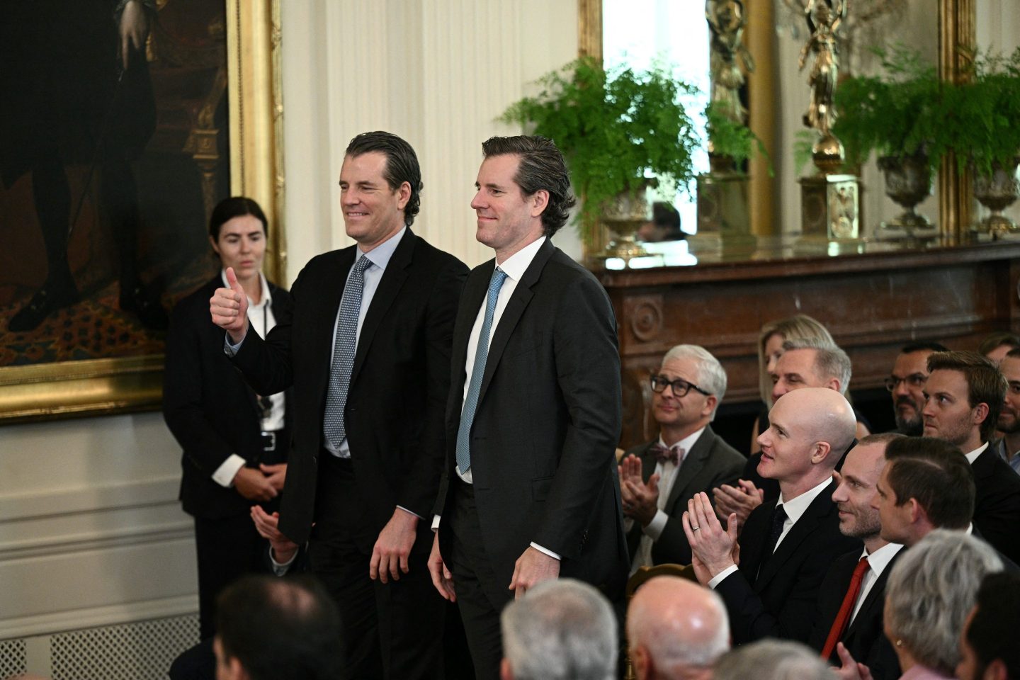 Entrepreneur twins Tyler Winklevoss (L) and Cameron Winklevoss attend the signing of the GENIUS Act, which codifies the use of stablecoins. The Winklevoss twins are part of a letter fighting against banks charging for access to consumer data. 