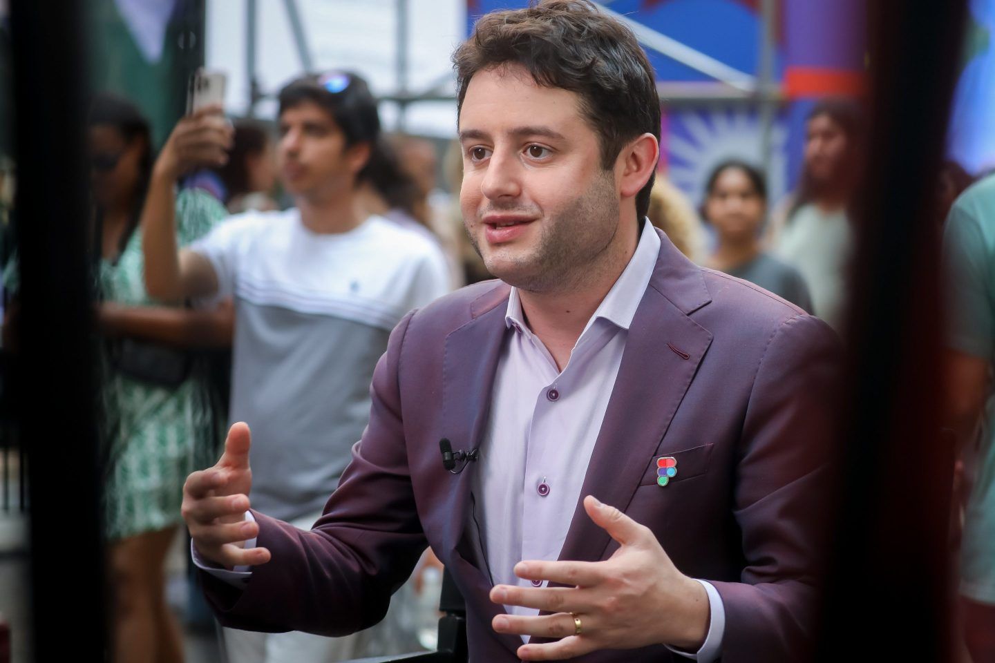 Dylan Field gestures with his arms while speaking