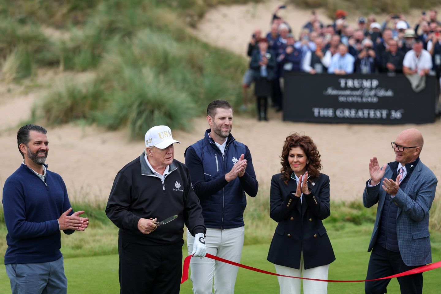 Donald Trump cuts the ribbon next to Donald Trump Jr. (L), Eric Trump (C), Sarah Malone, and Guy Kinnings (R)