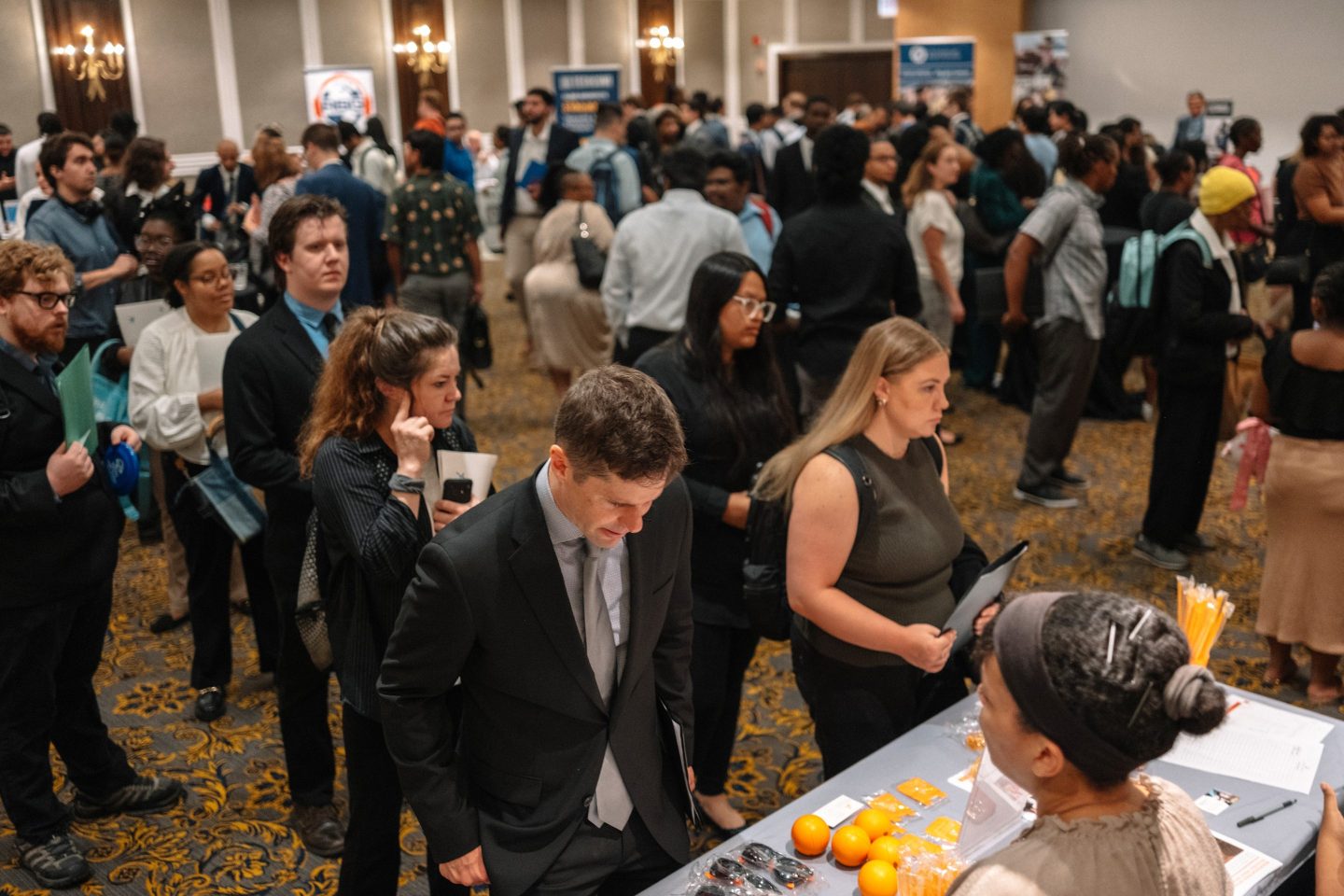 Job seekers wait in line to speak to recruiters during a career fair in Chicago on Thursday.