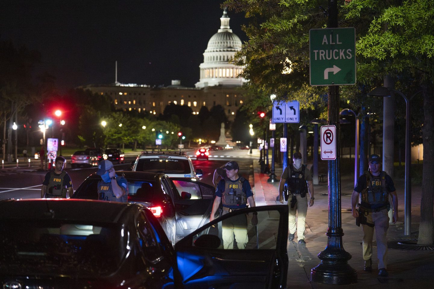 FBI agents search civilian cars at a checkpoint near the White House in Washington, D.C.