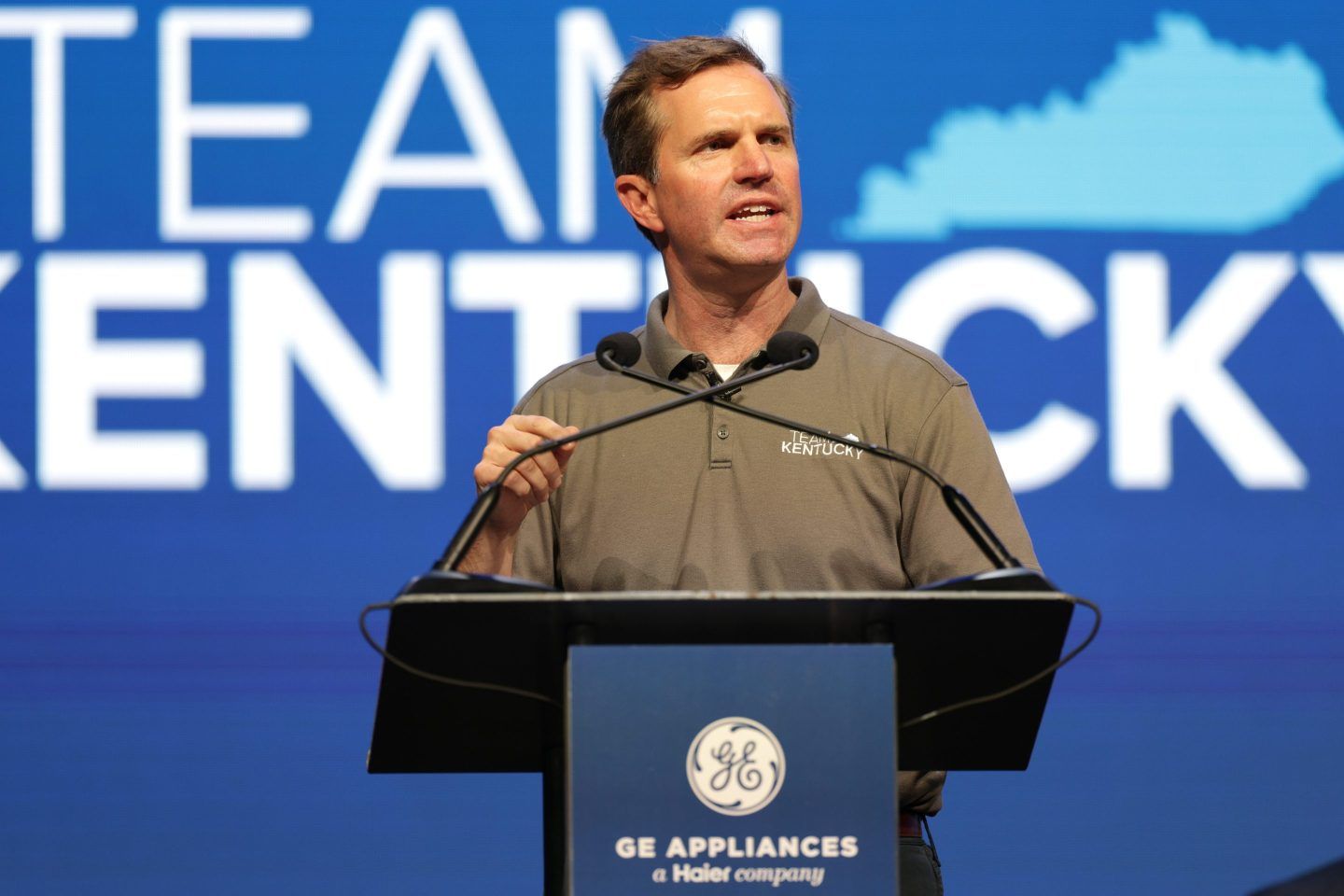 Kentucky governor Andy Beshear stands at a podium