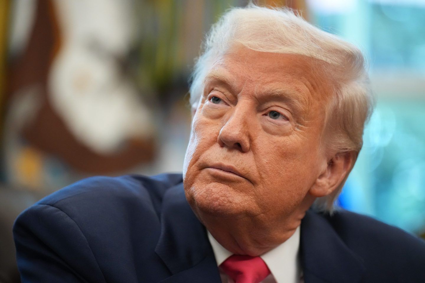 A photo of Donald Trump looking off image in a suit.