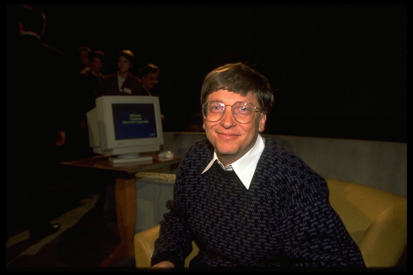 Bill Gates with an old computer behind
