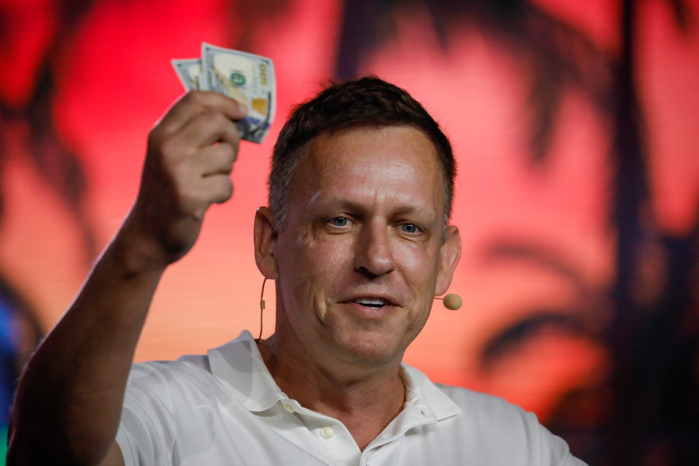 Palantir's Peter Thiel holds up a wad of cash