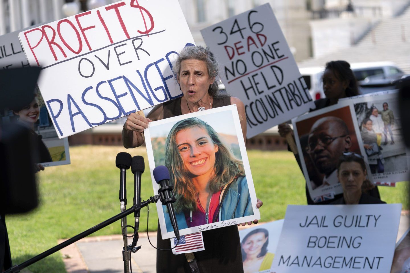 Nadia Milleron, parent of Samya Rose Stumo, one of the victims of the Boeing 737 Max crash in Ethiopia, holds her photograph and is surrounded by posters that say 'Profits over passanger' and other signs as she speaks at a news conference on Capitol Hill, June 18, 2024, in Washington.