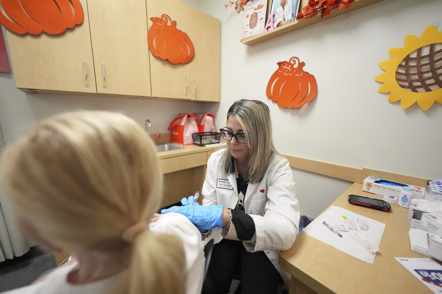 Pharmacy manager Aylen Amestoy administers a patient with a COVID-19 vaccine at a CVS Pharmacy in Miami on Sept. 9.