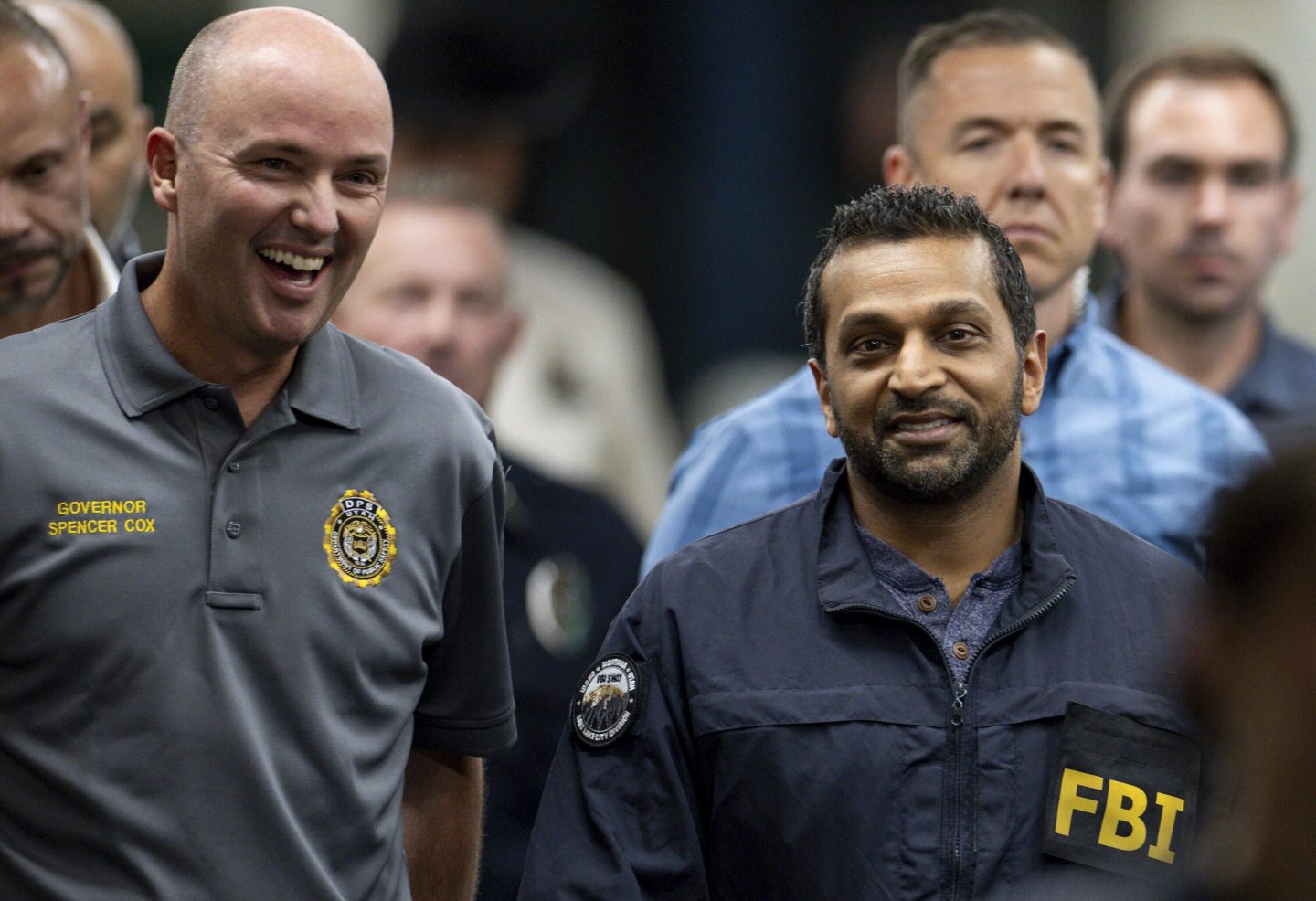 Utah Gov. Spencer Cox, left, and FBI Director Kash Patel, right, converse as they make their way to a press conference to speak to media about the shooting death of Charlie Kirk at Utah Valley University in Orem, Utah, on Thursday.