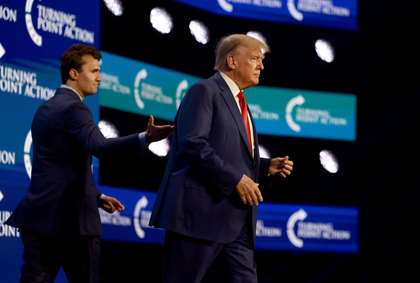 Charlie Kirk walks with Donald Trump