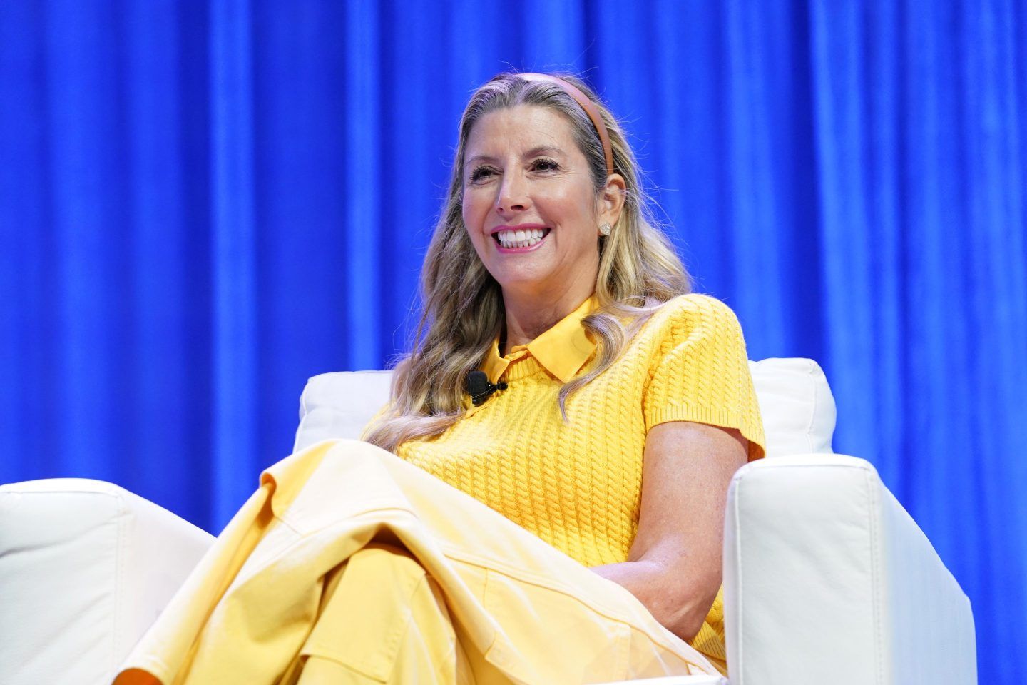 Sara Blakely smiles on stage