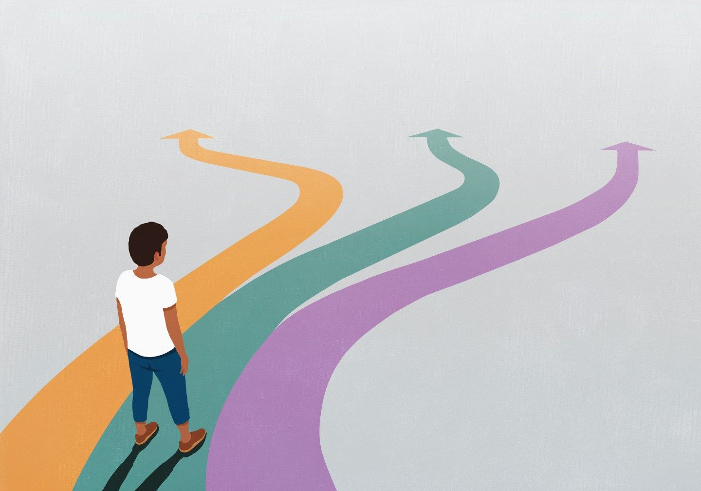 Man looking down at three multicolored arrow paths spreading before him