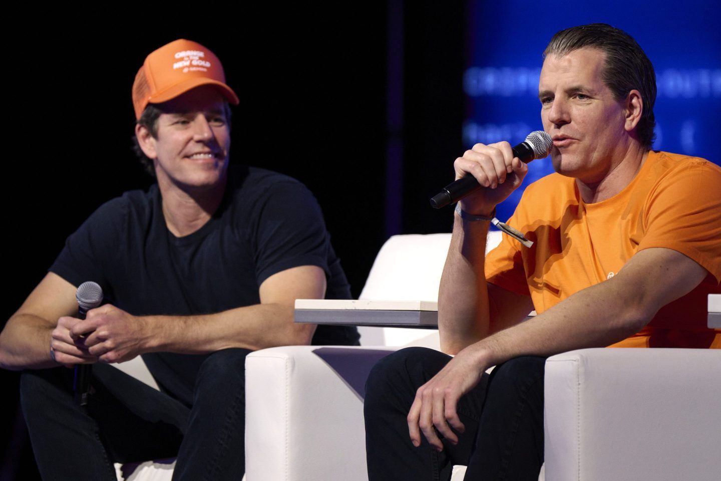 Cameron (left) and Tyler Winklevoss, cofounders of Gemini, on stage at a May crypto conference.