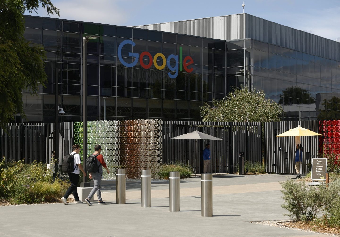 Workers enter a building on the Google headquarters campus in Mountain View, California, on July 23.