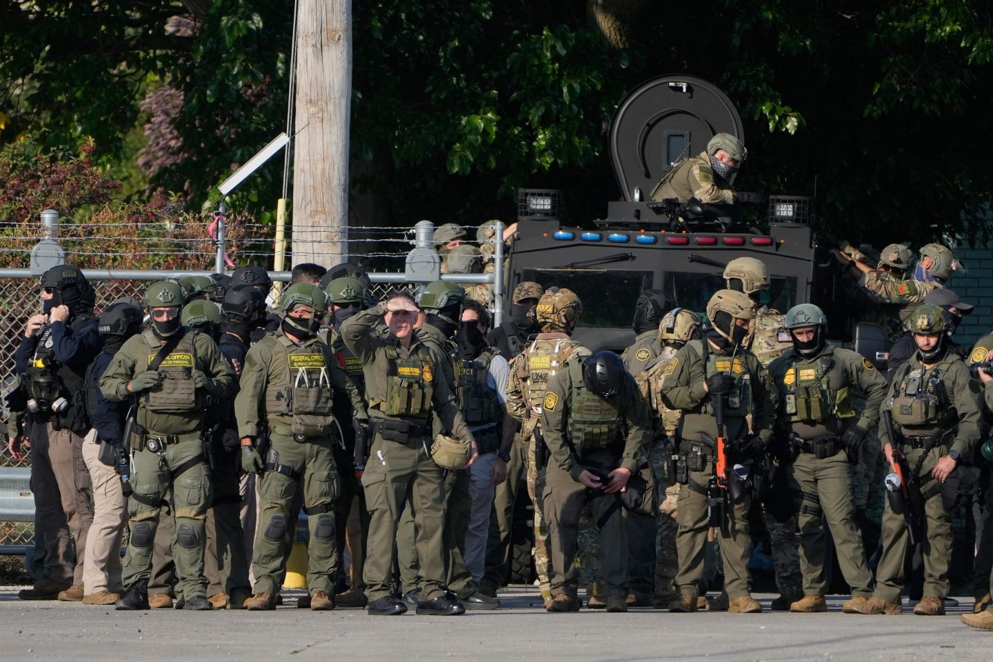 Greg Bovino, the chief patrol agent for the U.S. Border Patrol El Centro sector, center, stands with federal immigration agents near an Immigration and Customs Enforcement facility in Broadview, Ill., on Friday.