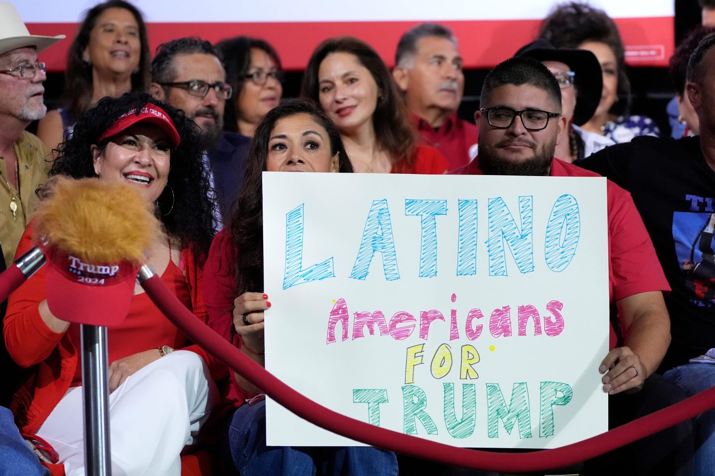 Supporters hold a sign before Republican presidential nominee former President Donald Trump arrives to speak during a campaign event, Sept.12, 2024, in Tucson, Ariz. (