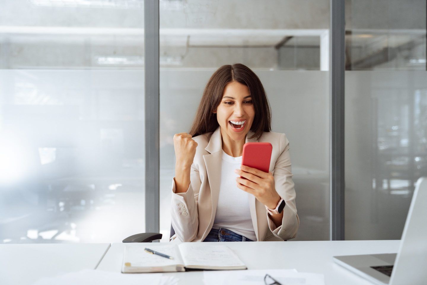 Worker happy getting news on phone