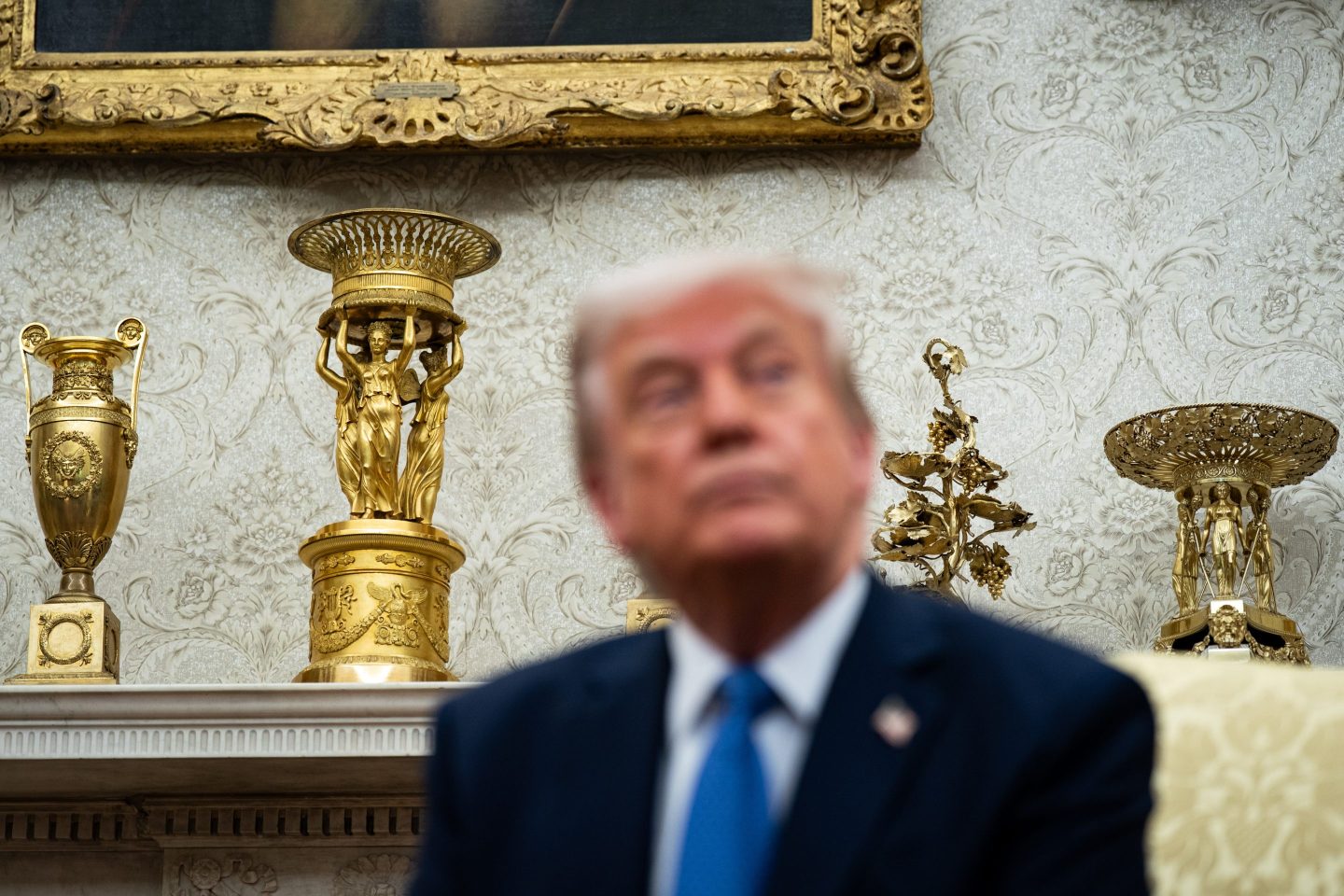 Gold decor on the mantle behind US President Donald Trump during a meeting with Jonas Gahr Store, Norway's prime minister, not pictured, in the Oval Office of the White House in Washington, DC, US, on Thursday, April 24, 2025.