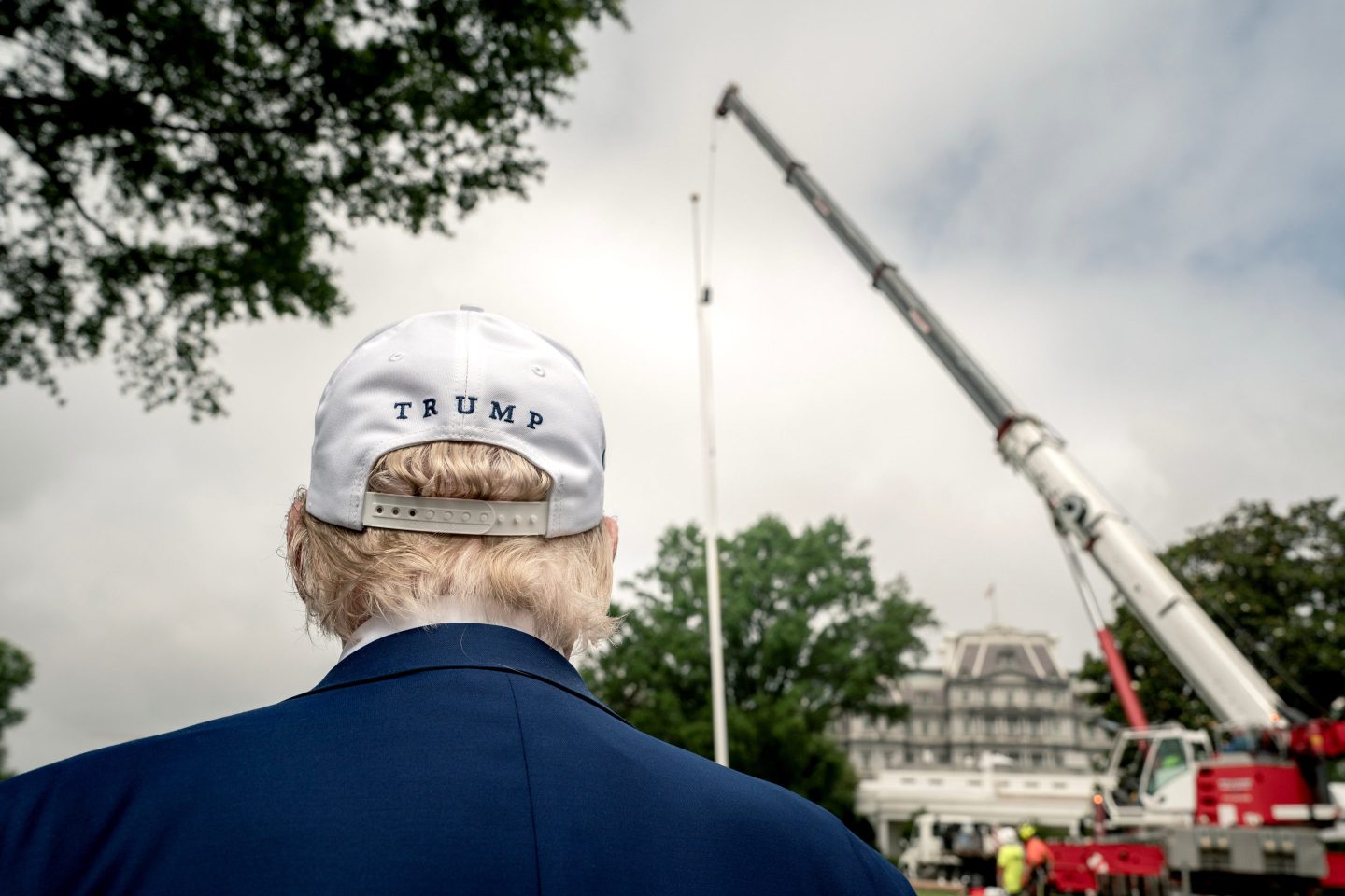 US President Donald Trump watches as workers install a new flagpole on the South Lawn of the White House in Washington, DC, US, on Wednesday, June 18, 2025.