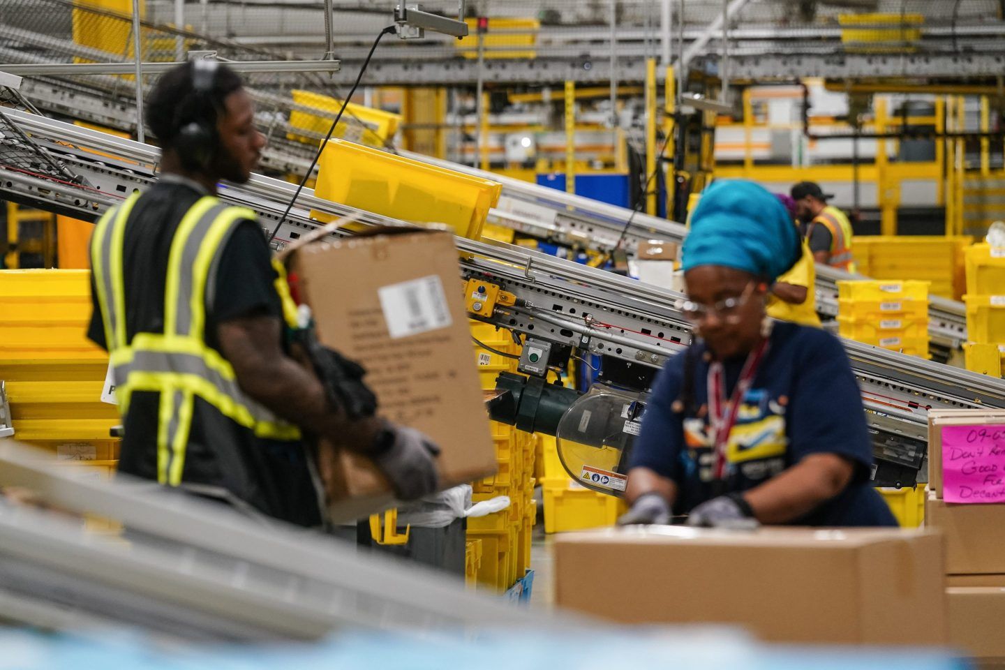 Amazon workers handling packages.