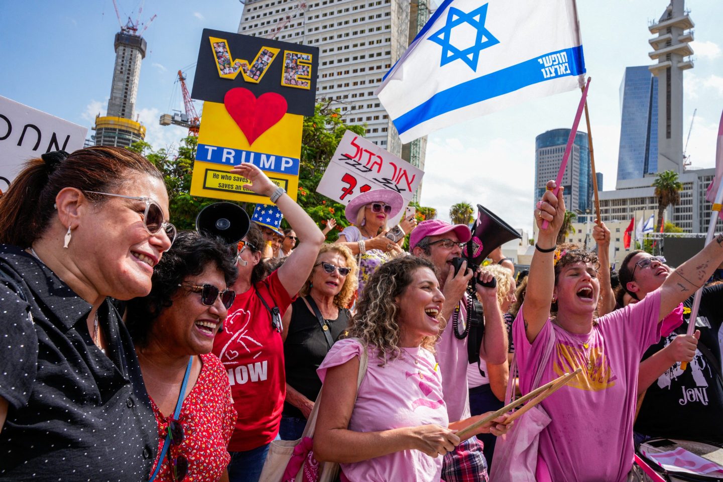 People celebrate at Hostage Square in Tel Aviv on October 9, 2025, following the announcement of the new Gaza ceasefire deal. Israel and Hamas on October 9 agreed a Gaza ceasefire deal to free the remaining living hostages, in a major step towards ending a war that has killed tens of thousands of people and unleashed a humanitarian catastrophe.