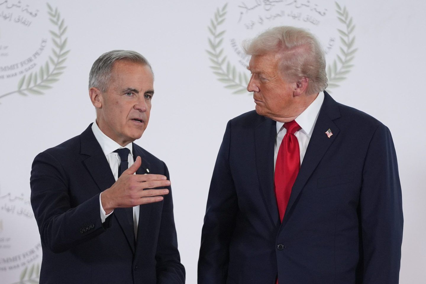 President Donald Trump greets Canada's Prime Minister Mark Carney on Oct. 13, 2025, in Sharm El Sheikh, Egypt.
