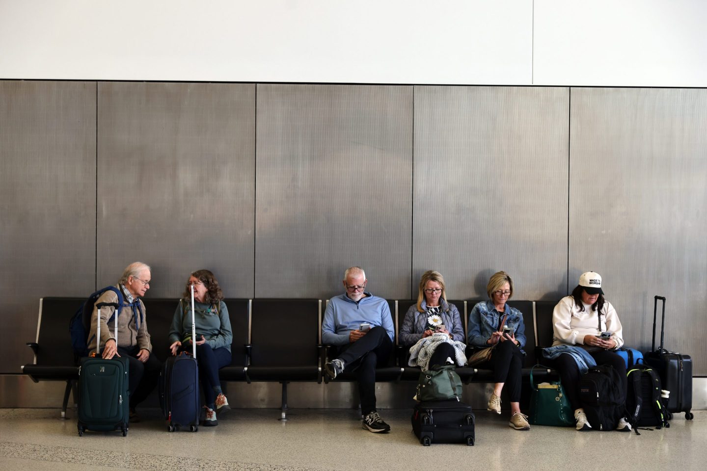 Travelers wait and check for their flights at San Francisco International Airport on Friday, Nov. 7, 2025. 
