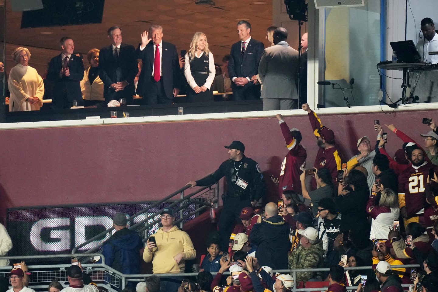 President Donald Trump is seen in a suite during the first half of an NFL football game between the Washington Commanders and the Detroit Lions Sunday, Nov. 9, 2025, in Landover, Md. 