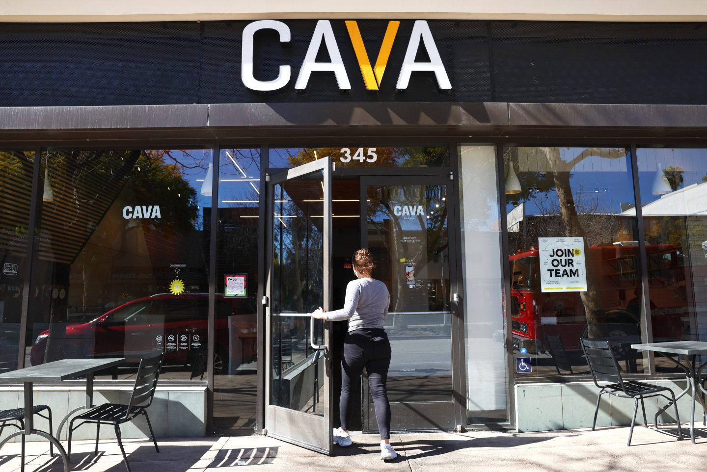 A customer enters a Cava restaurant chain location.