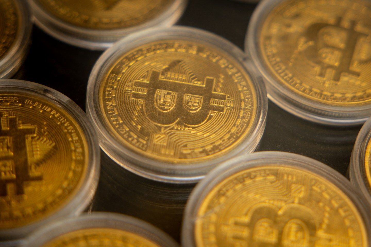 picture of gold coins with bitcoin logo on it