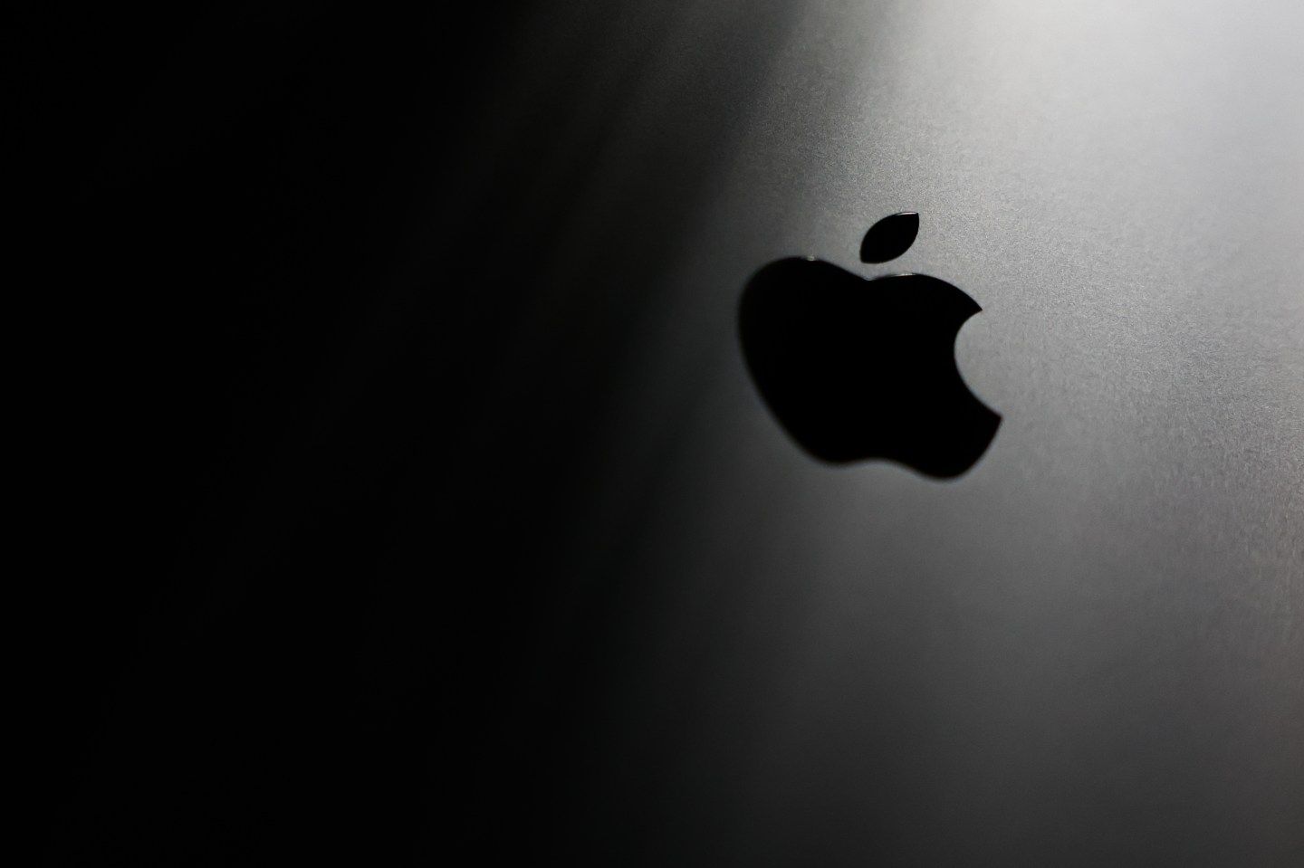 An Apple logo appearing on a MacBook laptop in 2025. (Photo: Jakub Porzycki/NurPhoto/Getty Images)