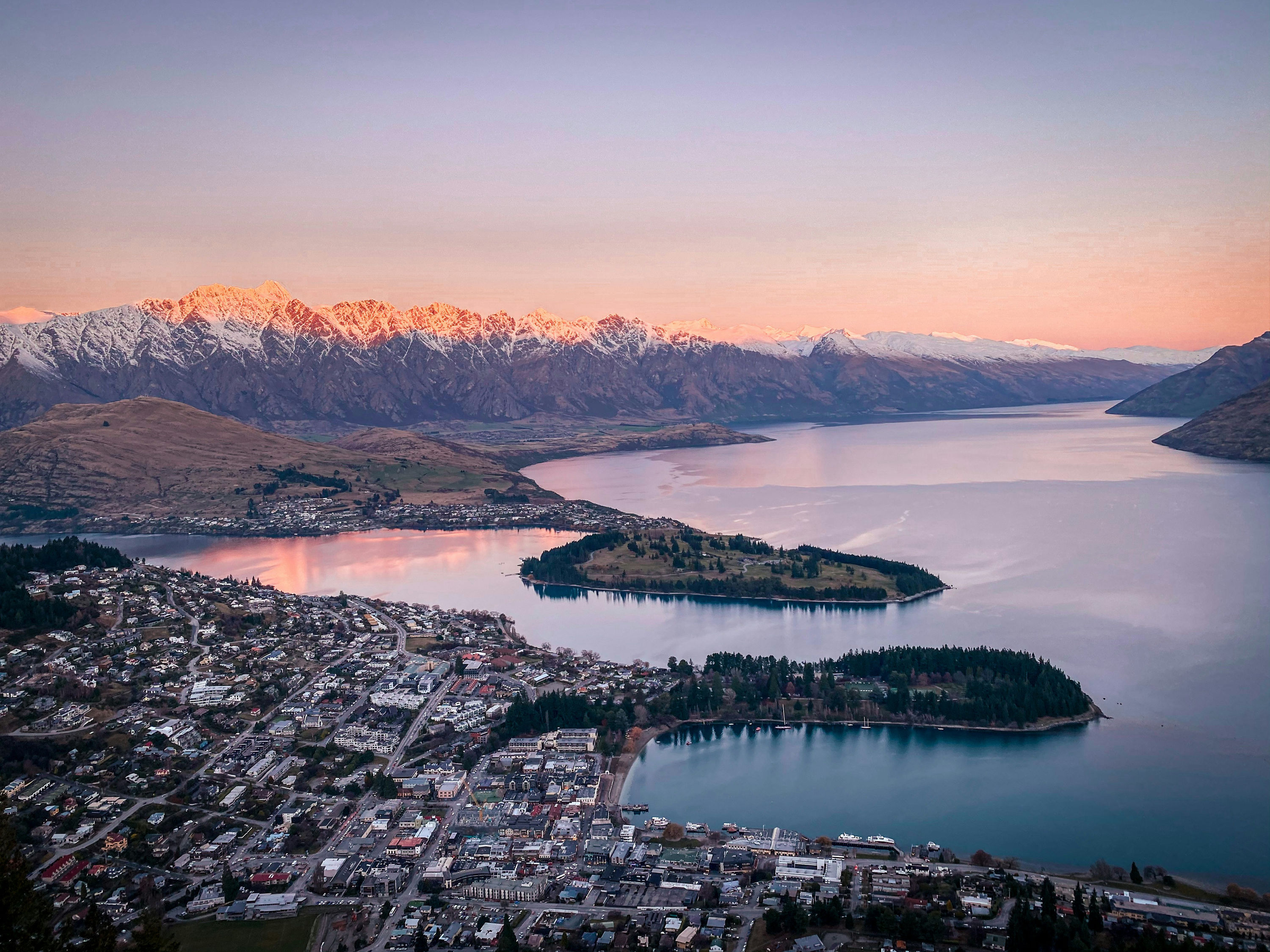 Queenstown and Lake Wakatipu at sunrise beneath the snow-capped Remarkables.