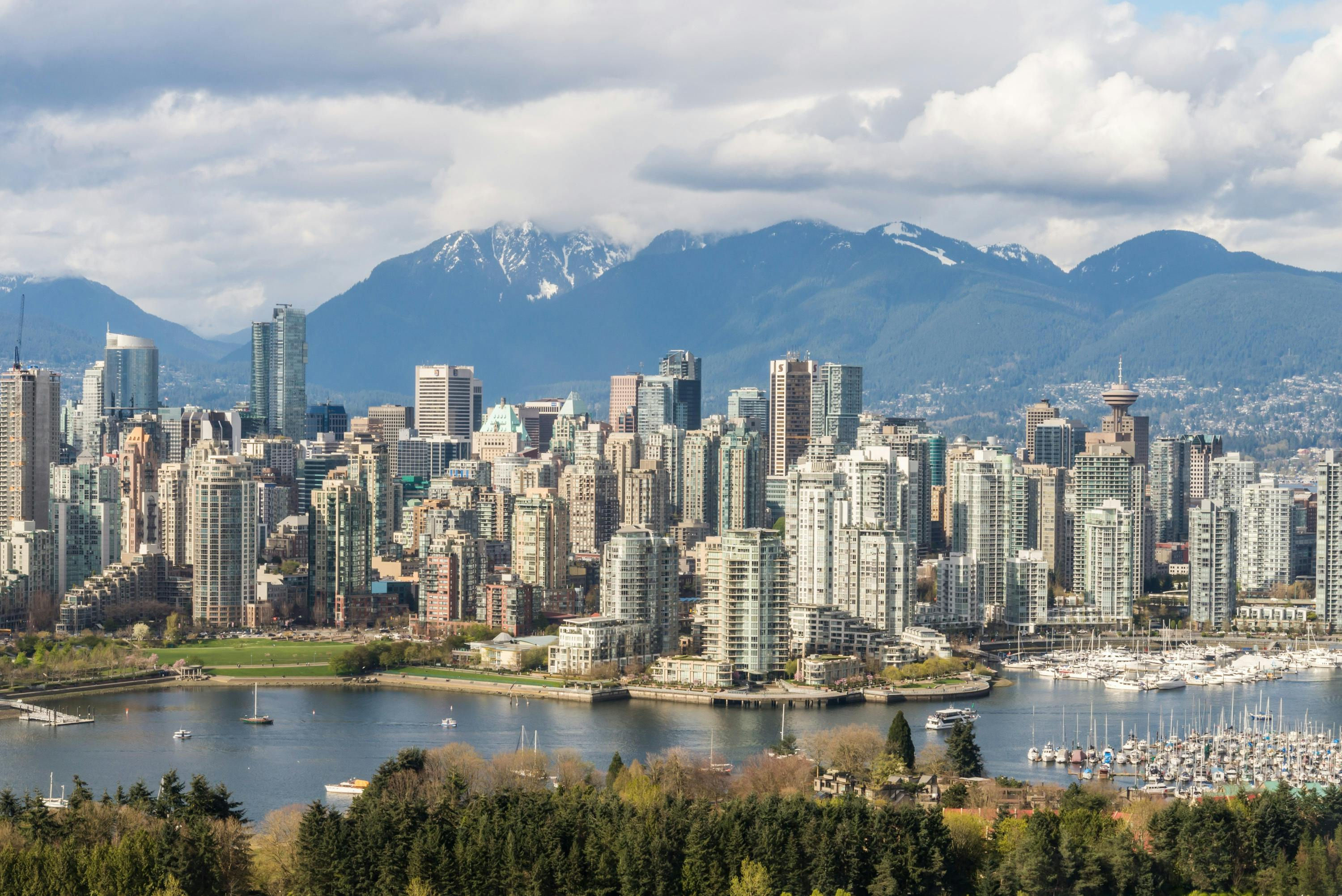 The Vancouver skyline backed by snow-capped mountains.