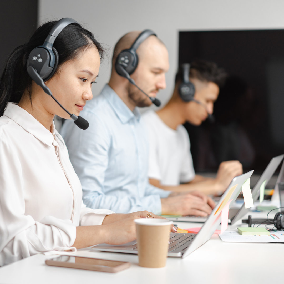 three people in a shared office space