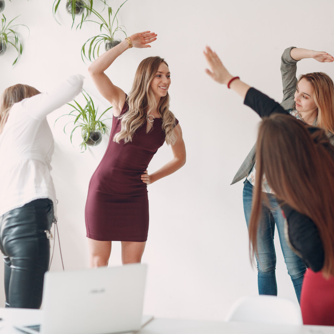 women doing exercising in a modern workspace