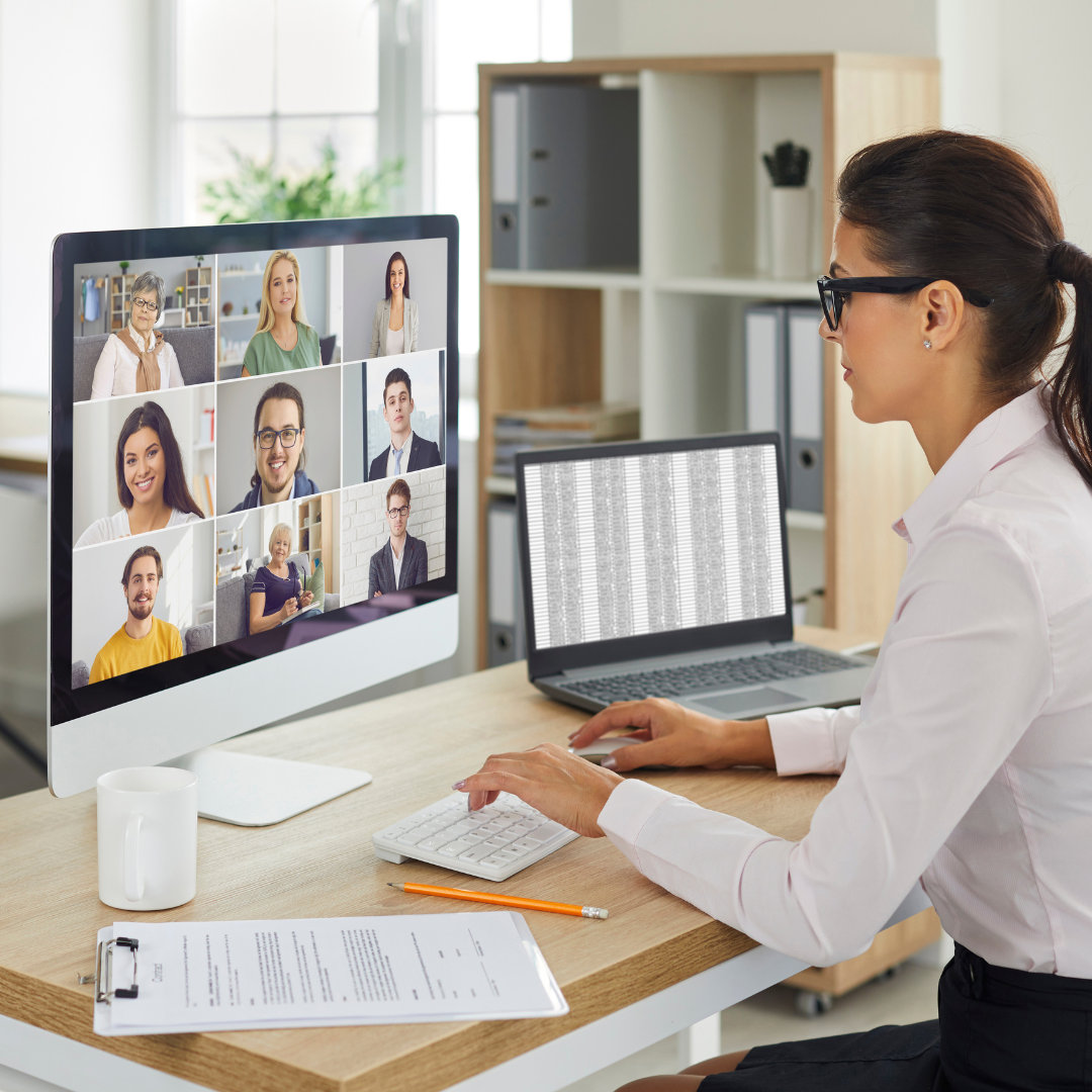 a woman meeting with other people virtually