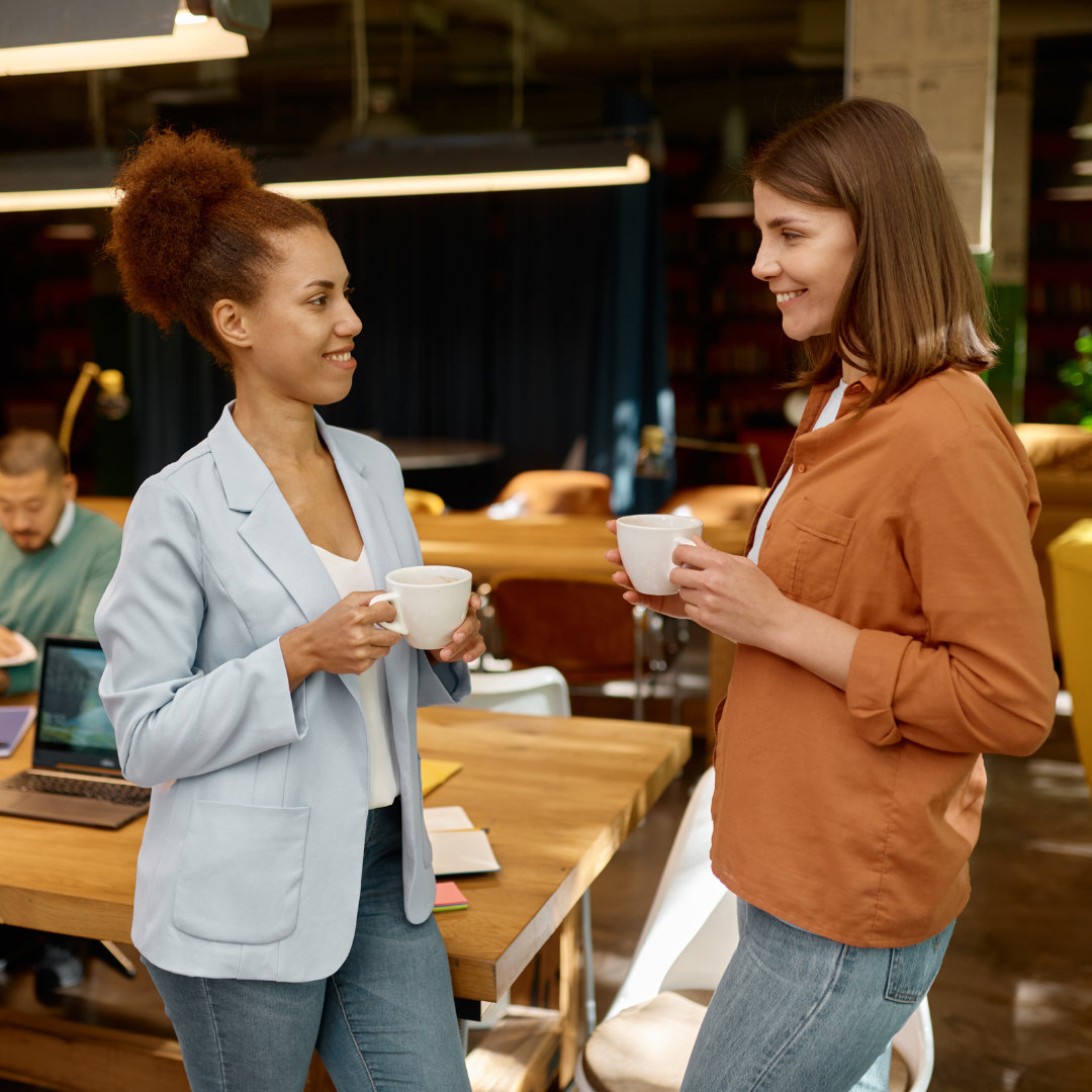 two ladies holding a cup of coffee