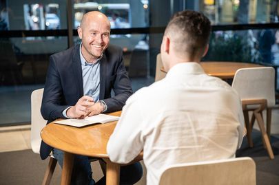 CEO and employee discussing business over a table-top