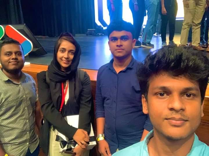 Aweesha Wijesundara with keynote speakers in front of the stage at Google DevFest Sri Lanka 2022